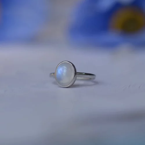 Introducing the Celestial Glow Moonstone Ring, a beautiful piece of sterling silver jewelry featuring a mesmerizing iridescent moonstone.